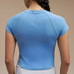 Back view of model wearing light blue dance tee 