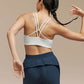 Back side of woman wearing white bra and navy blue joggers