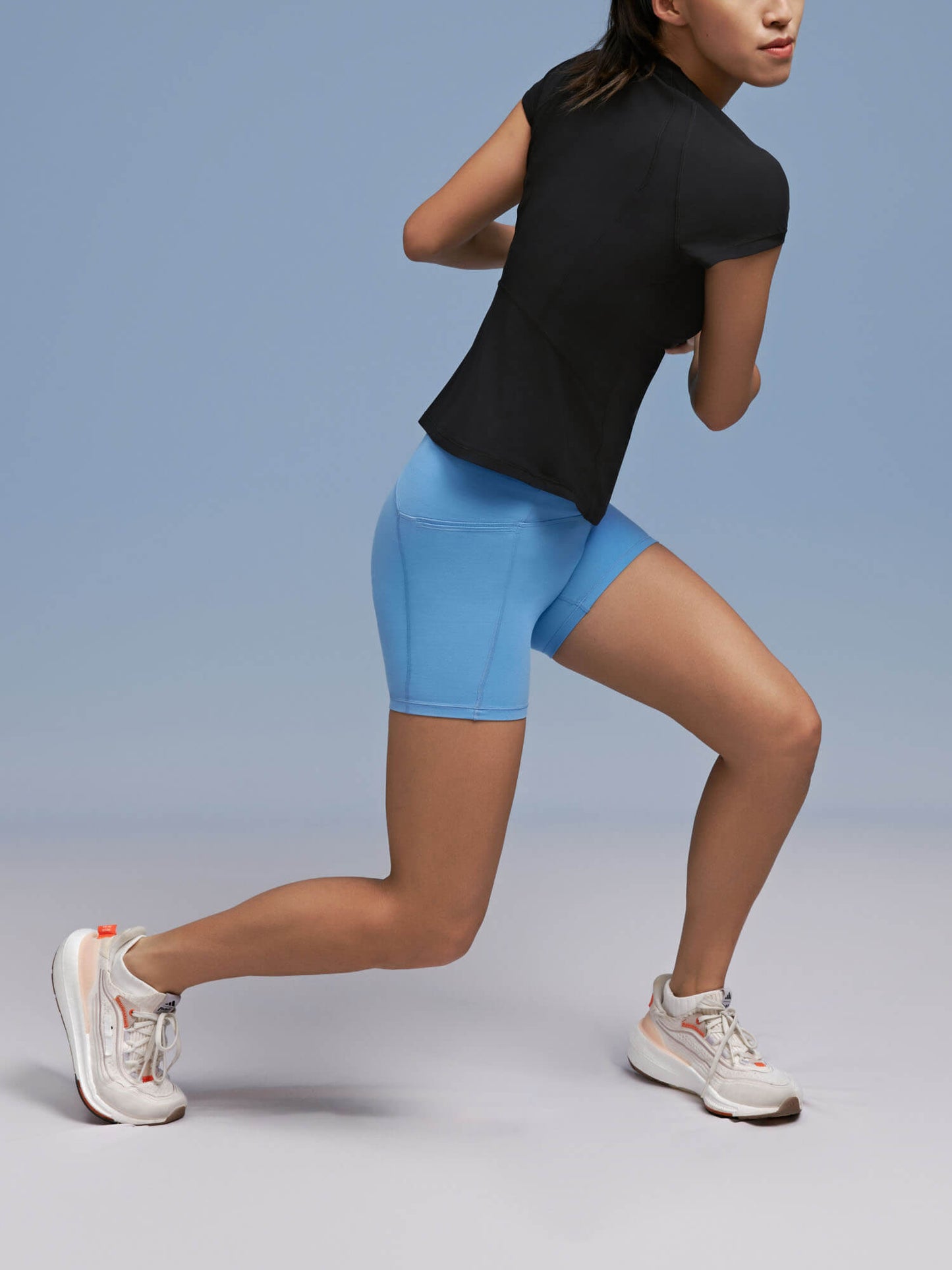 Model wearing black tee and light blue biker shorts