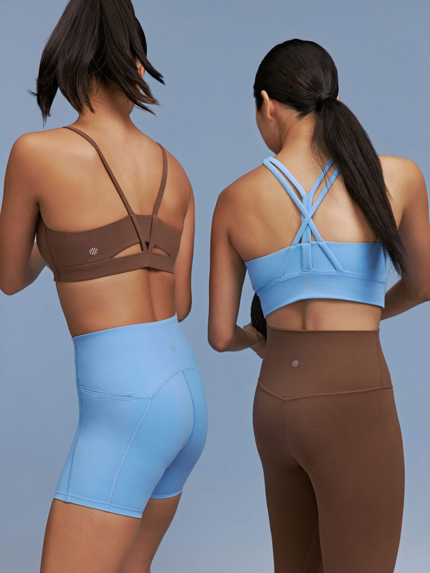 Back view of two models wearing active sets 