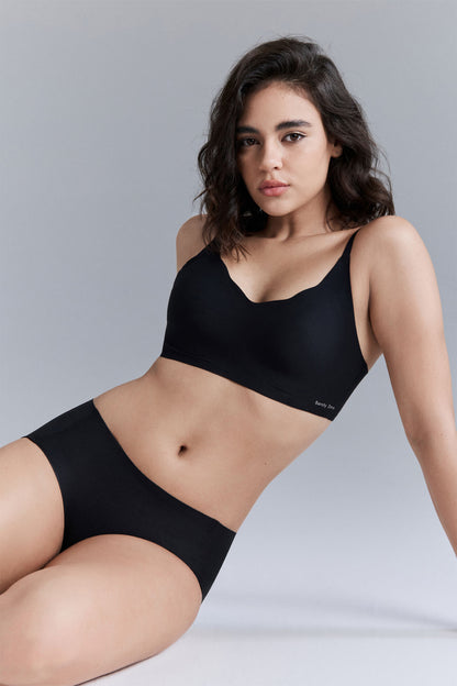 Model wearing black wavy bra and brief set.