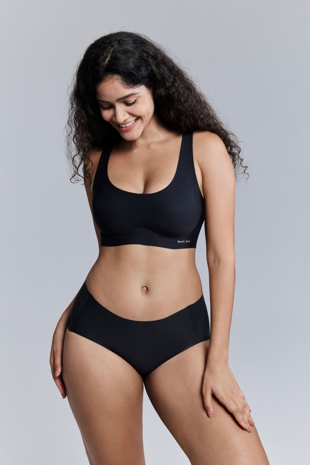 Model wearing black bra and brief set