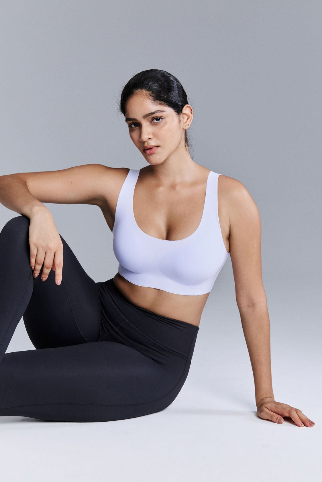 Model wearing light purple bra and black leggings