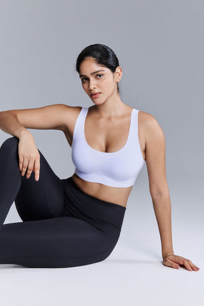 Model wearing light purple bra and black leggings