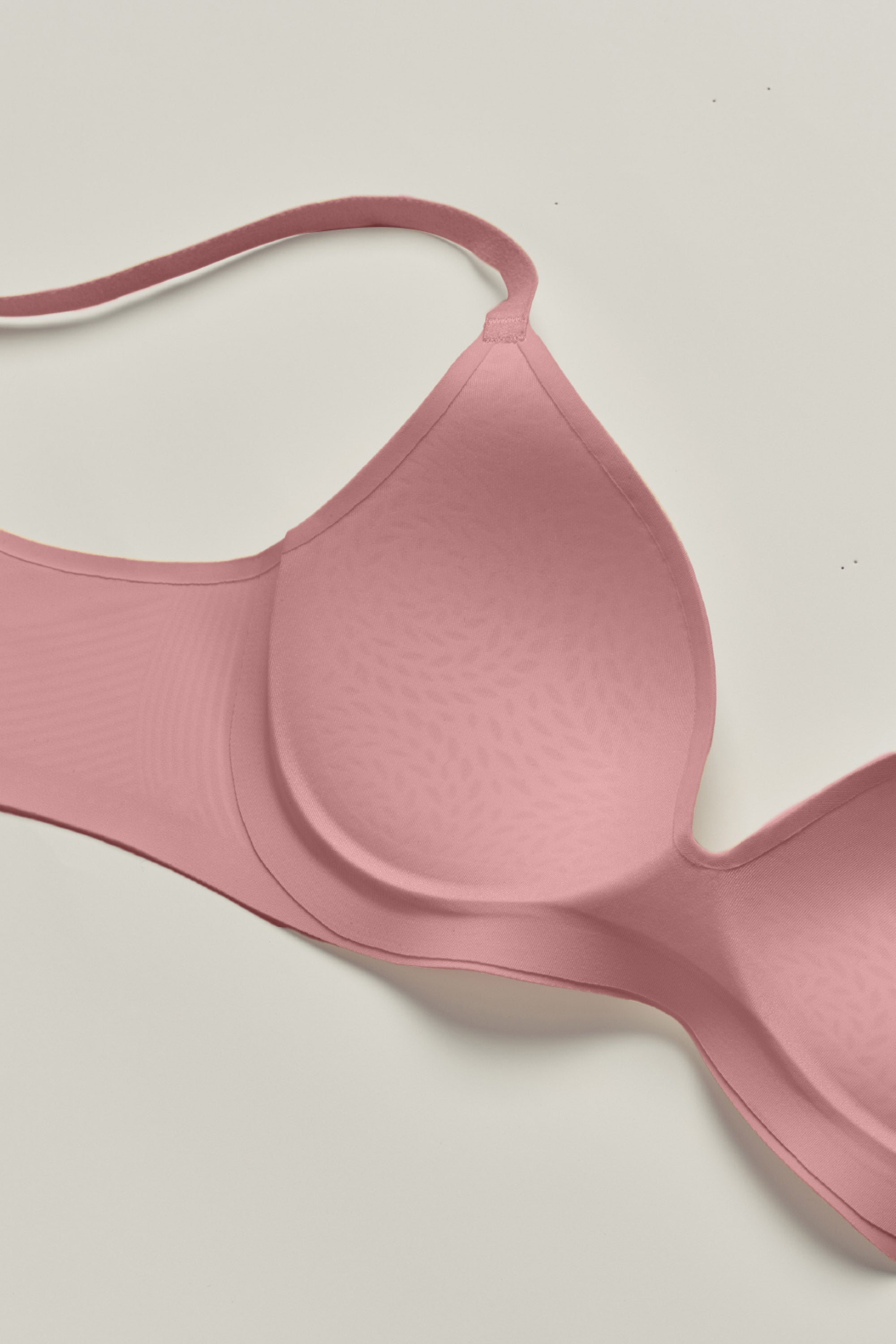 Pink bra on a light gray background