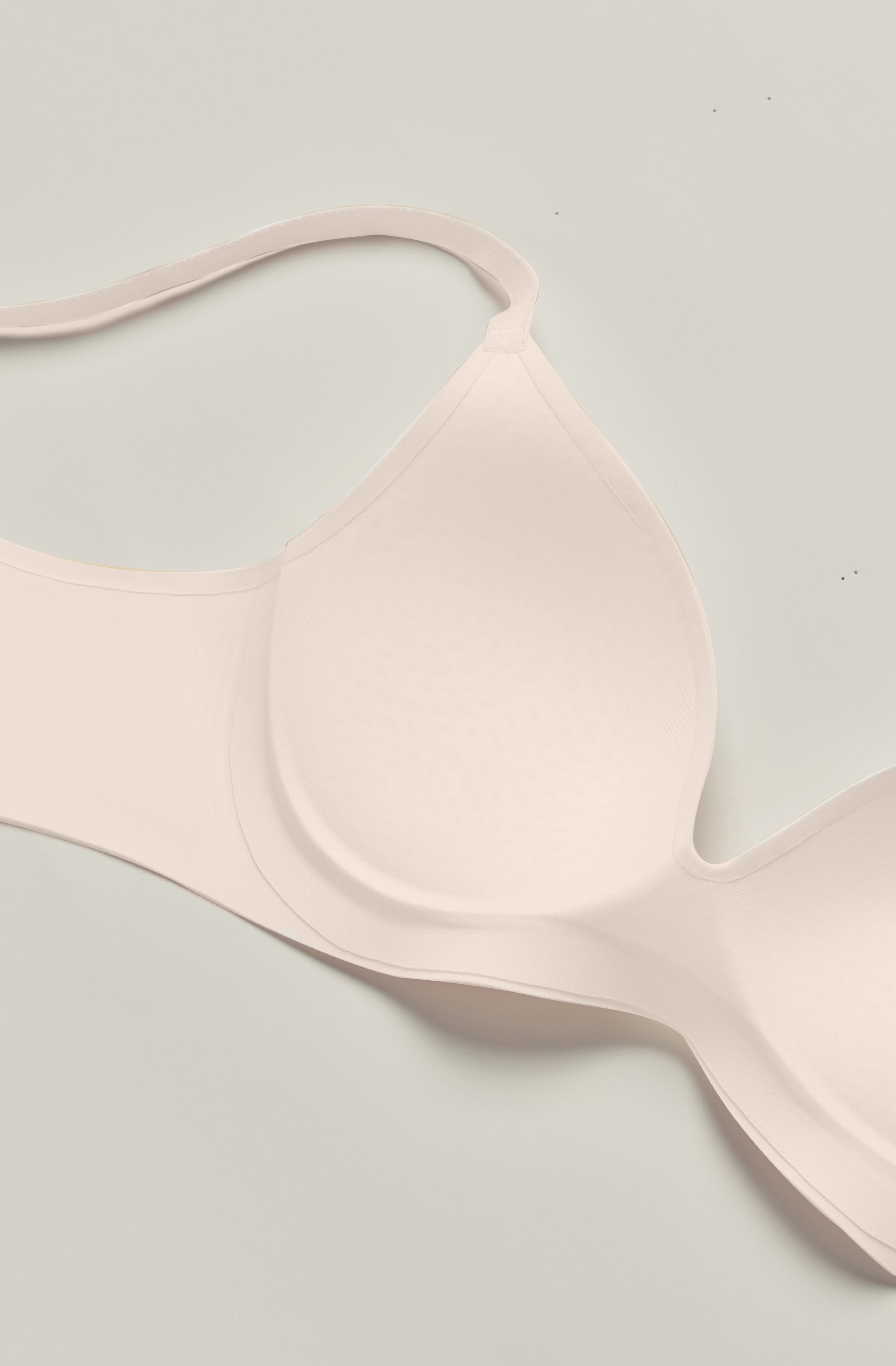 Pink bralette on a light gray background