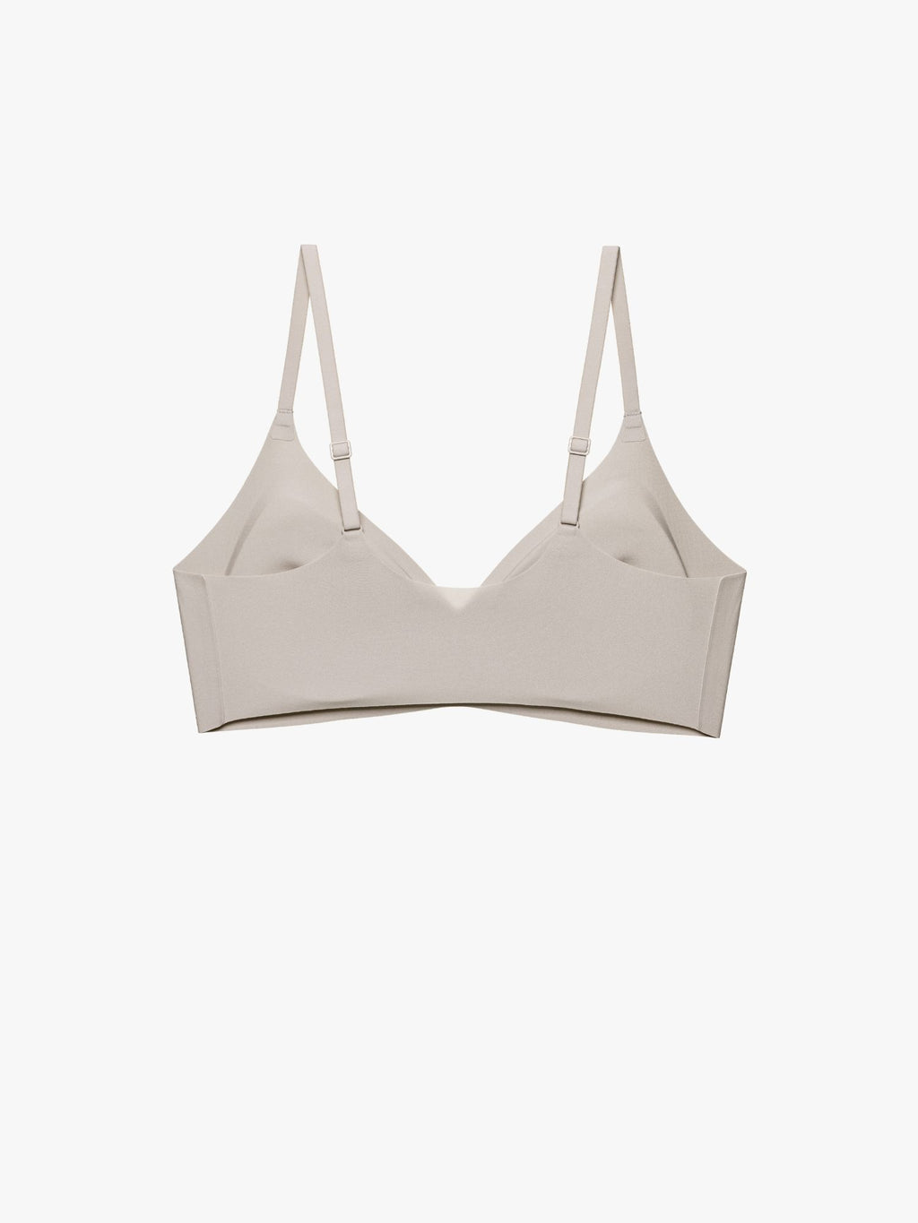 A light beige wireless bra with thin adjustable shoulder straps, displayed flat against a solid off-white background. Chateau Gray