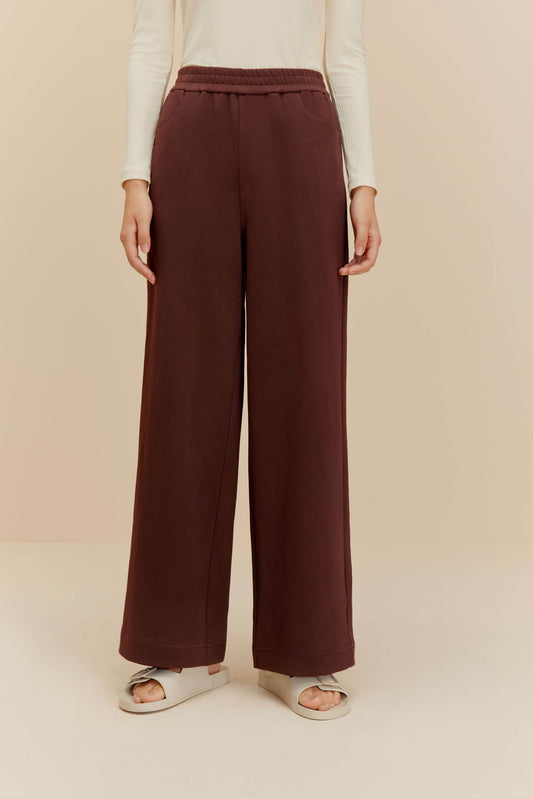 Woman wearing brown wide-leg pants