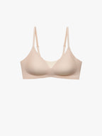 A light beige wireless underwire bra with adjustable shoulder straps, shown against a plain white background. Treacly Almond