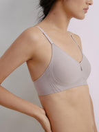 Side view of woman wearing light gray bra with center cutout detail. Sphinx color.