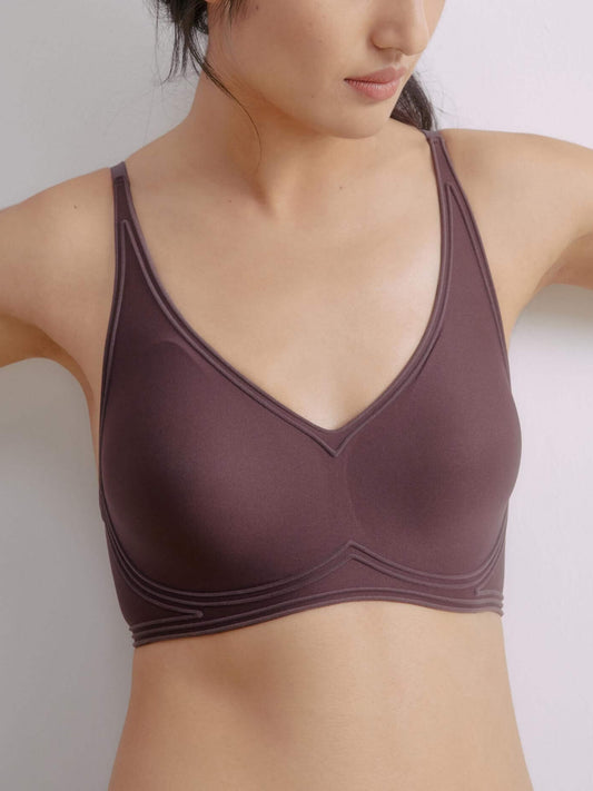 Woman wearing plunge bra in chocolate brown