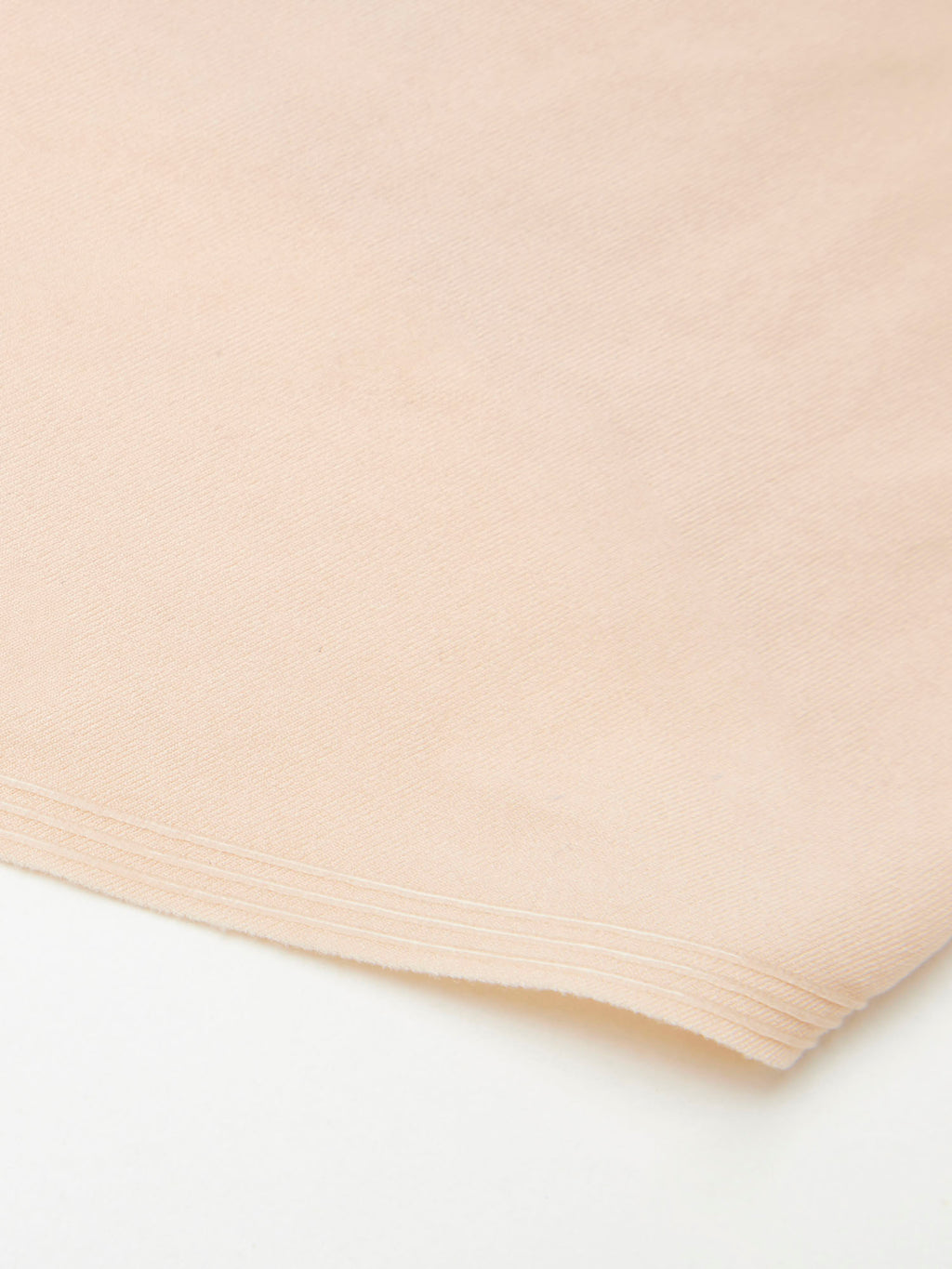 Beige fabric with pleated texture on a white background