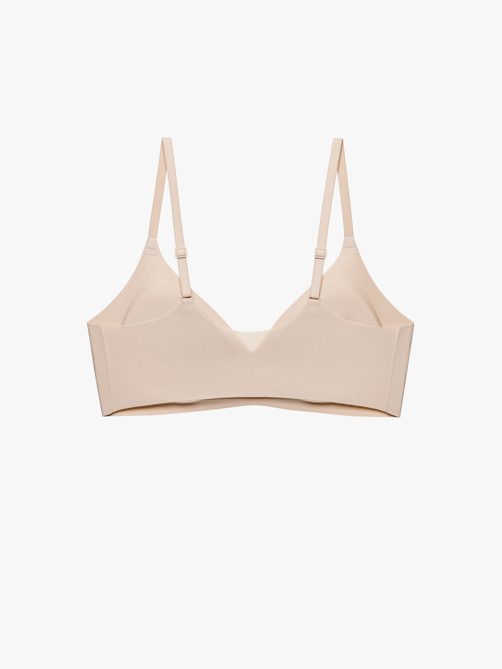 A light beige wireless bra with thin adjustable shoulder straps, displayed against a clean white background. Treacly Almond