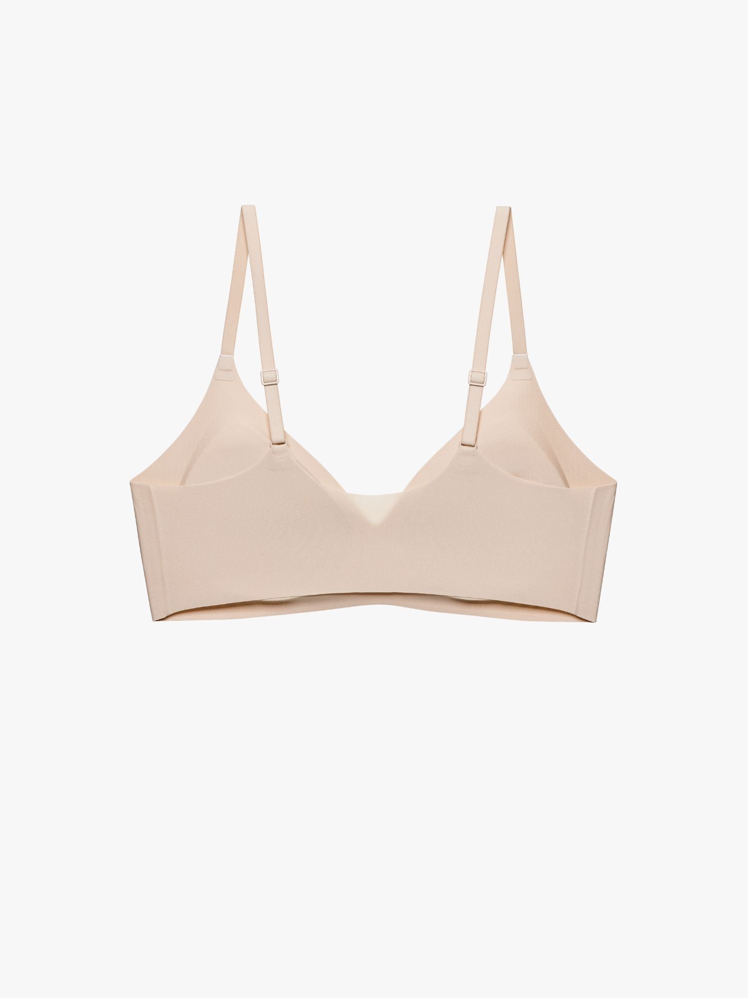 A light beige wireless bra with thin adjustable shoulder straps, displayed against a clean white background. Treacly Almond