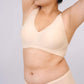 Woman wearing light beige bra with plunge neckline