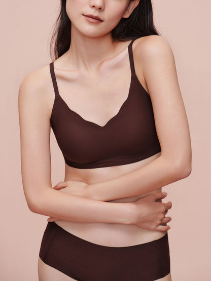 Model wearing brown bra and brief set.