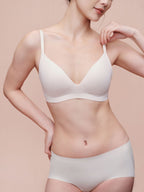 Model wearing white bra and brief set.