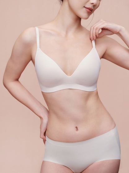 Model wearing white bra and brief set.