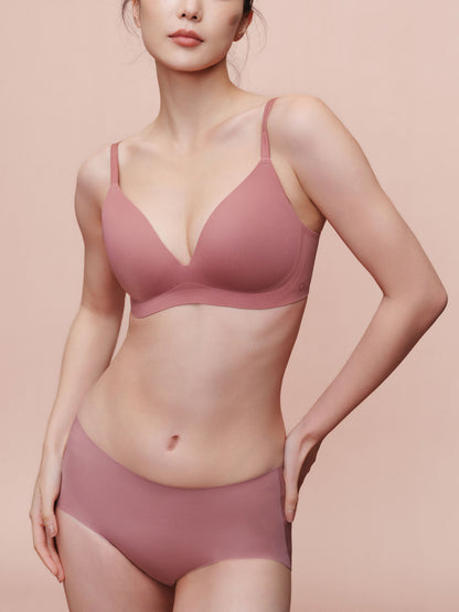 Model wearing light pink bra and brief set.