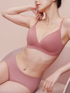 Model wearing light pink bra and brief set.