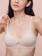 Model wearing a beige bra with keyhole detailing.