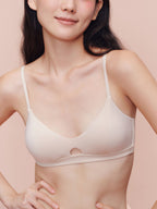 Model wearing a beige bra with keyhole detailing.