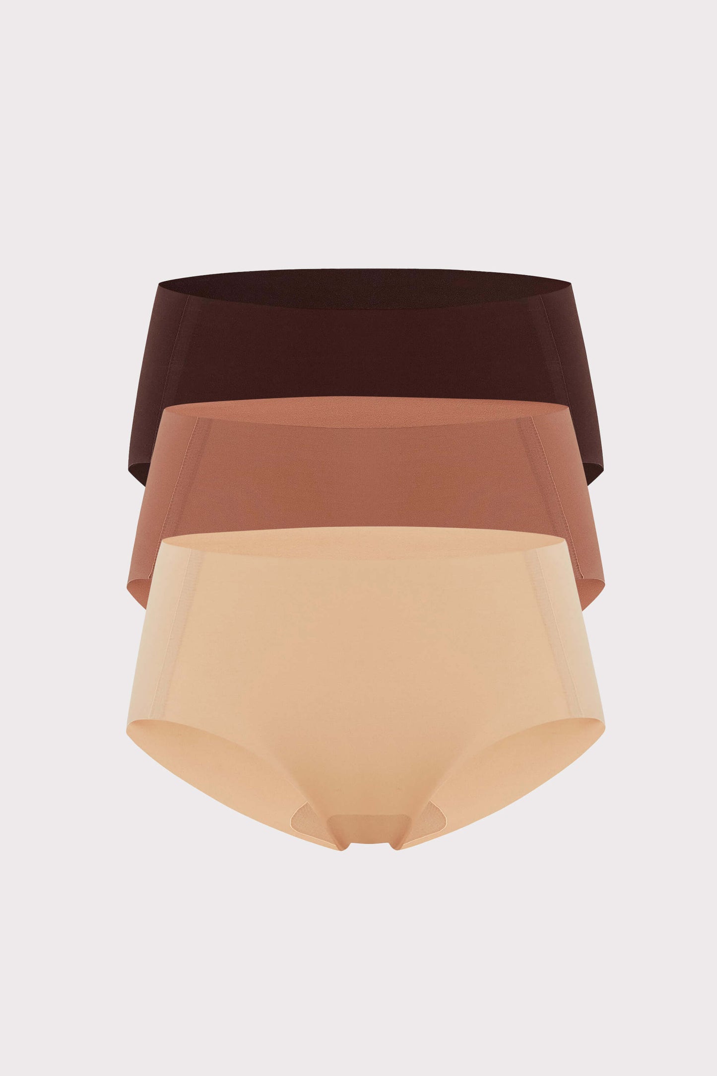 Flat lay image of brown, rust-colored, and beige underwear