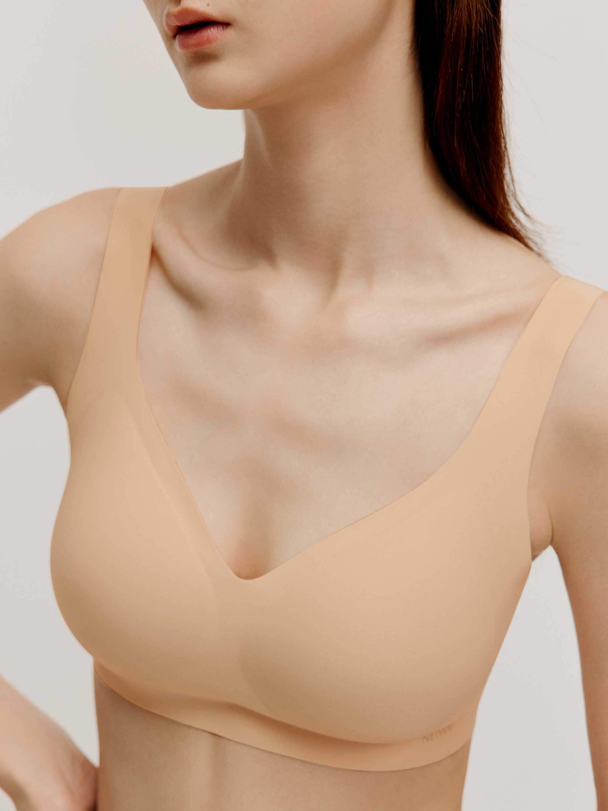 front close up of woman wearing light nude bra