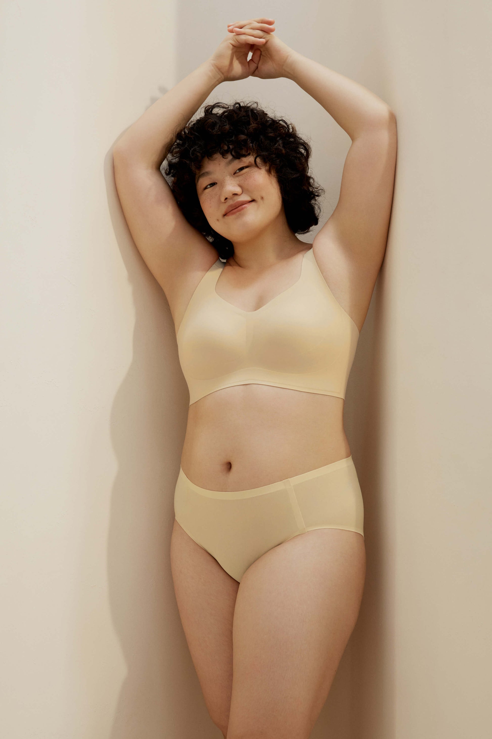 woman wearing light yellow bra and matching panties