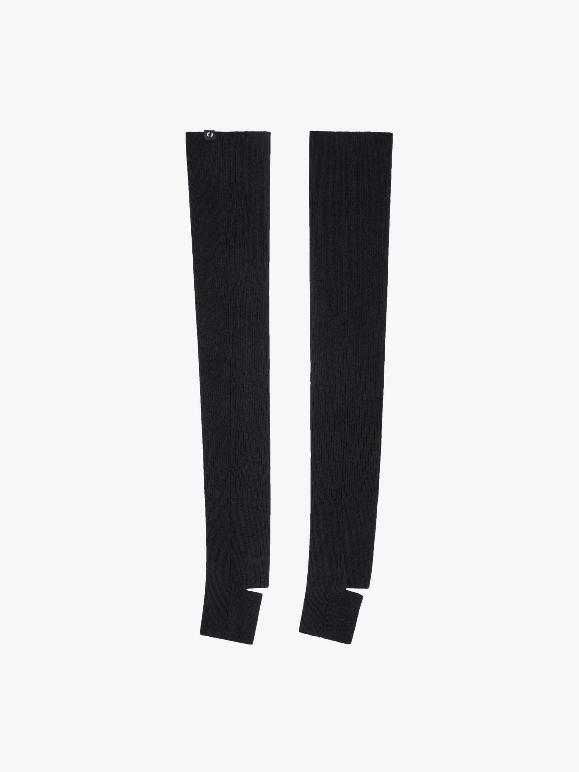 Flat lay image of black leg warmers with stirrups