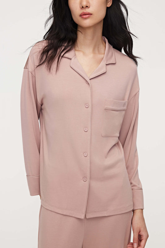 A woman wearing a pink pajama shirt