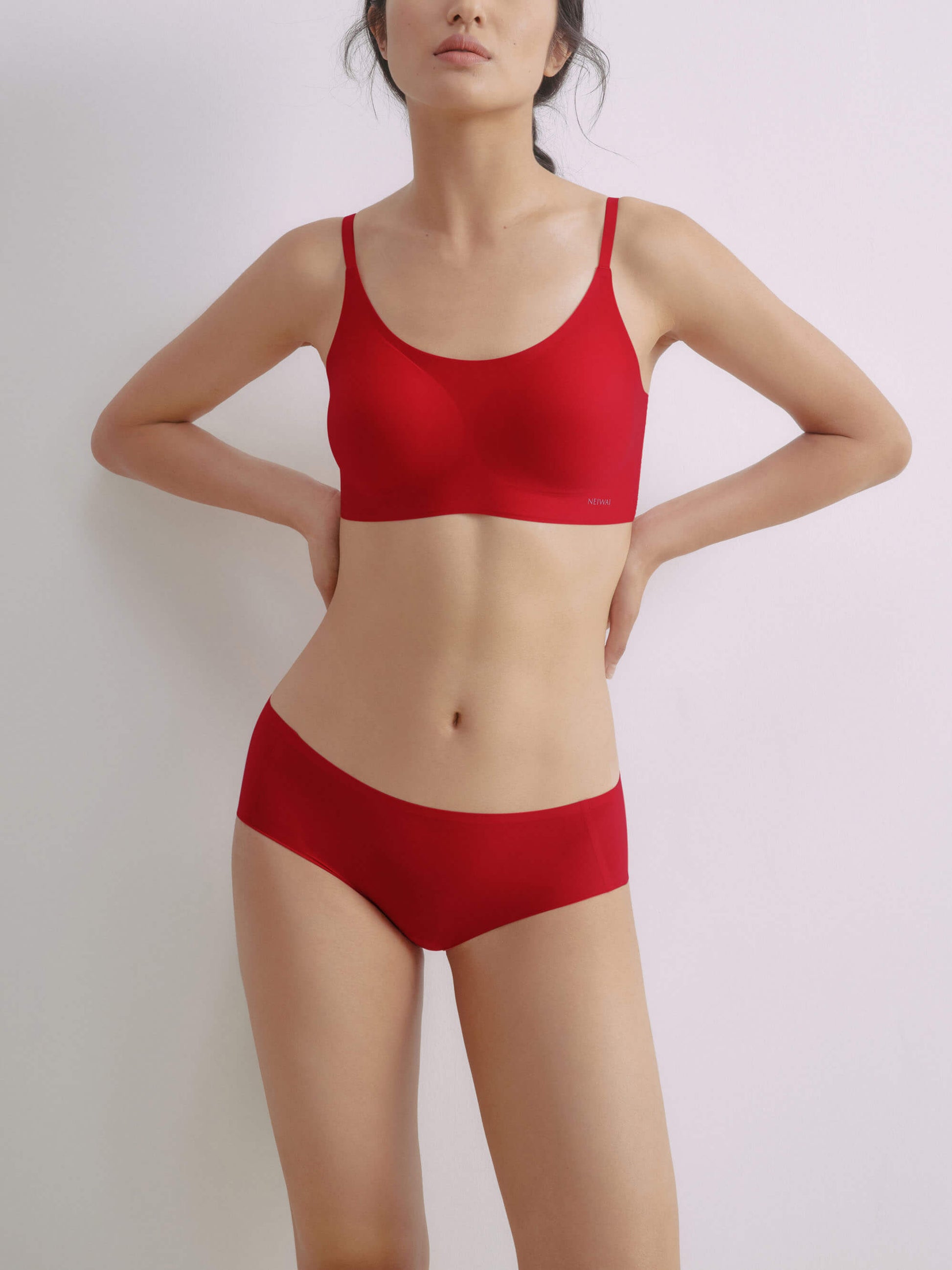 Woman wearing matching red bra and briefs