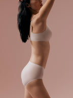 Side view of model wearing light mauve bra and brief set
