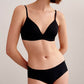 Full body view of model wearing matching black bra and brief set