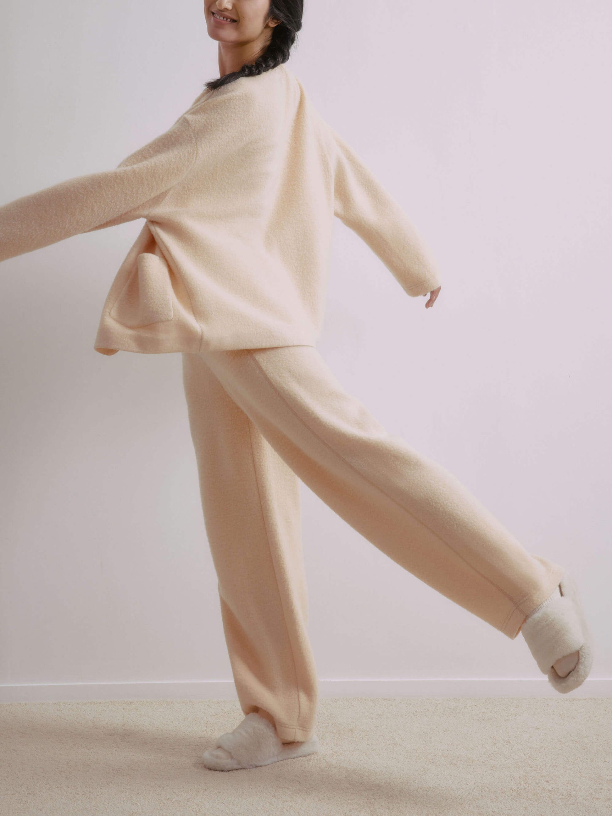 Side view of woman wearing wool fleece pants