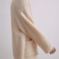 Side view of woman wearing cream colored wool fleece jacket