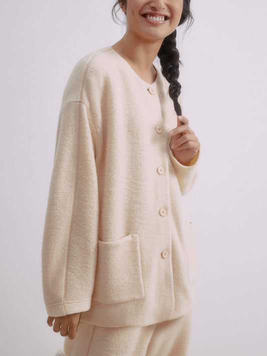 Woman wearing buttoned cream colored wool fleece jacket