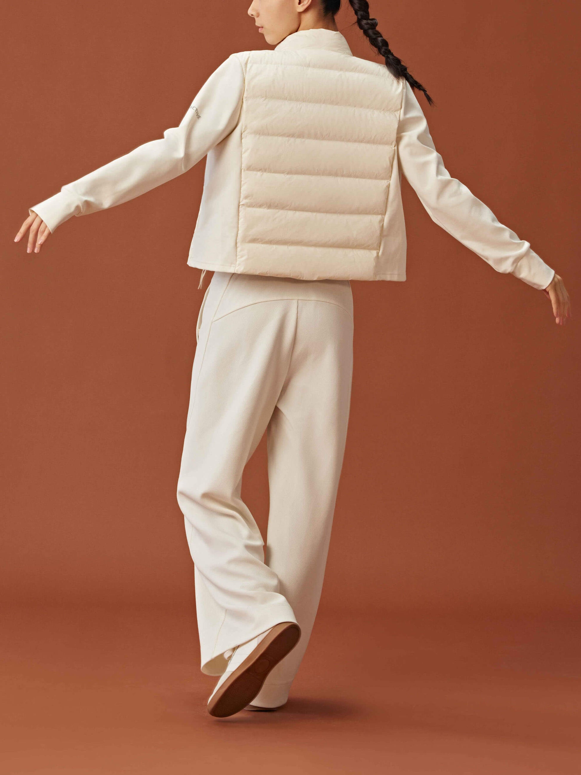 Back view of woman wearing white cropped jacket