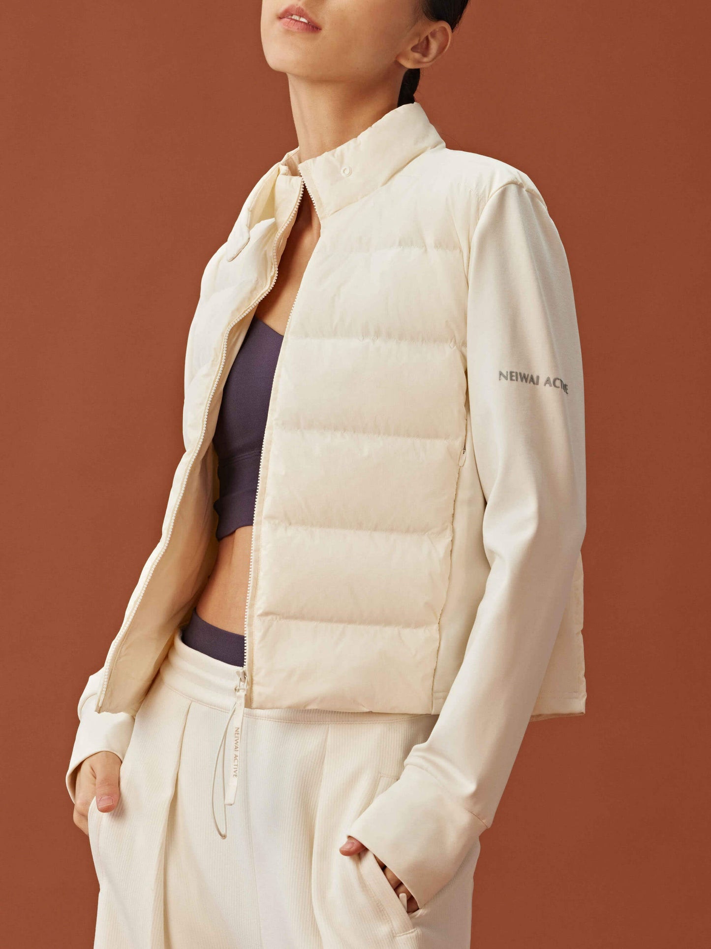 Woman wearing white cropped jacket unzipped