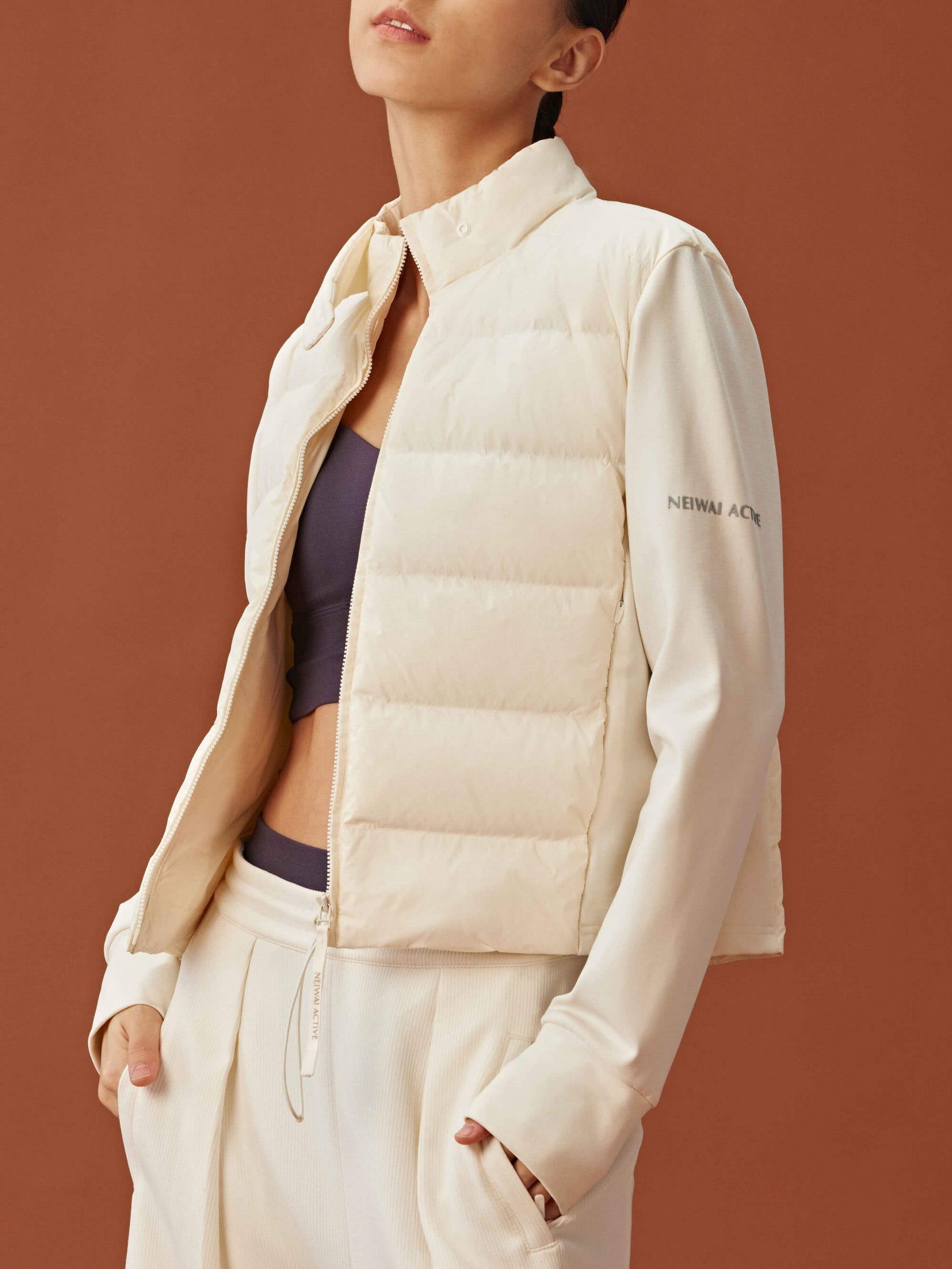 Woman wearing white cropped jacket unzipped