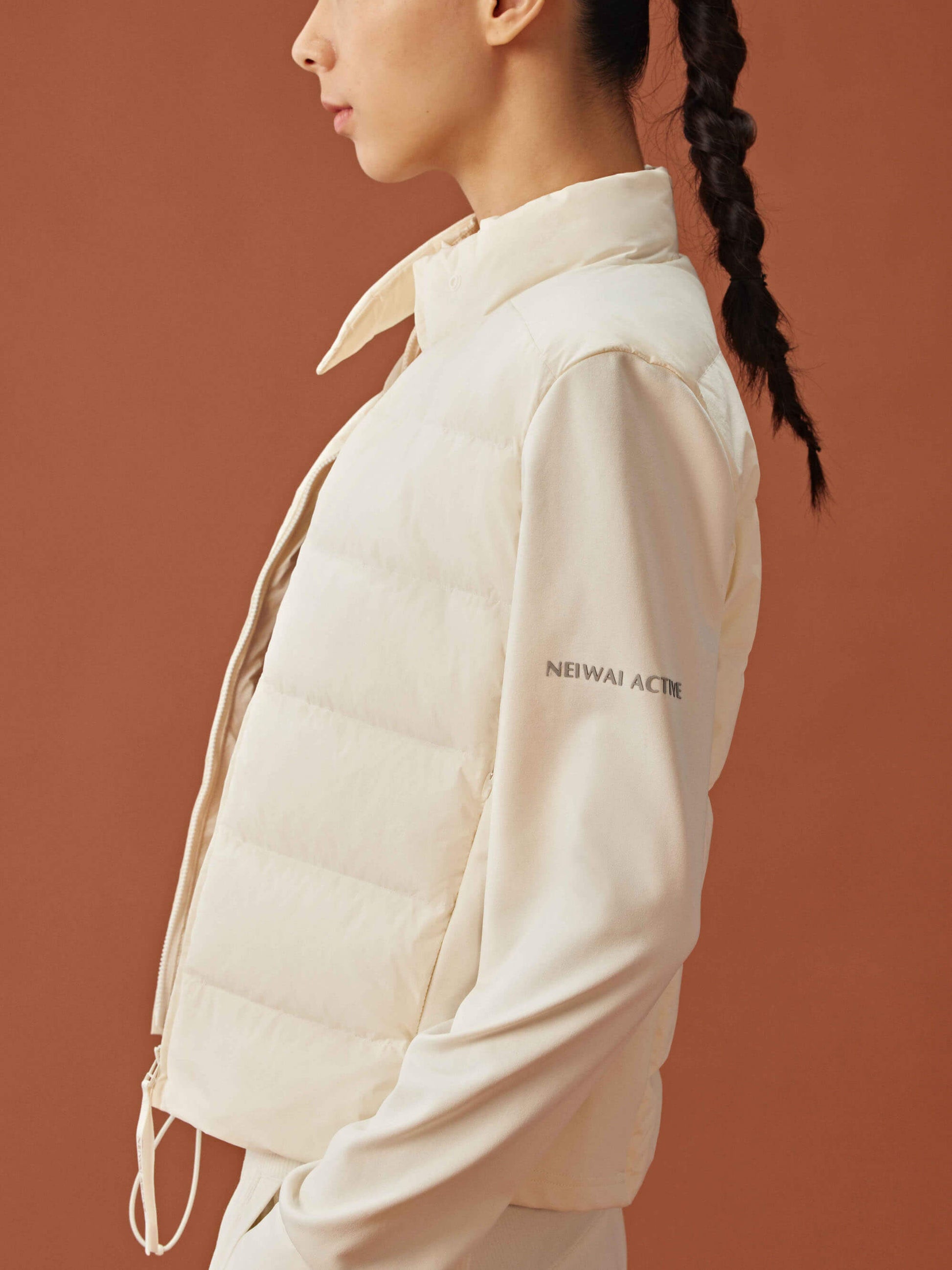 Side view of woman wearing white cropped jacket