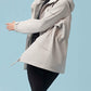 Woman wearing zipped up gray hooded coat