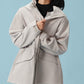 Woman wearing gray hooded coat