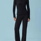 Front view of woman wearing black woven fleece pants