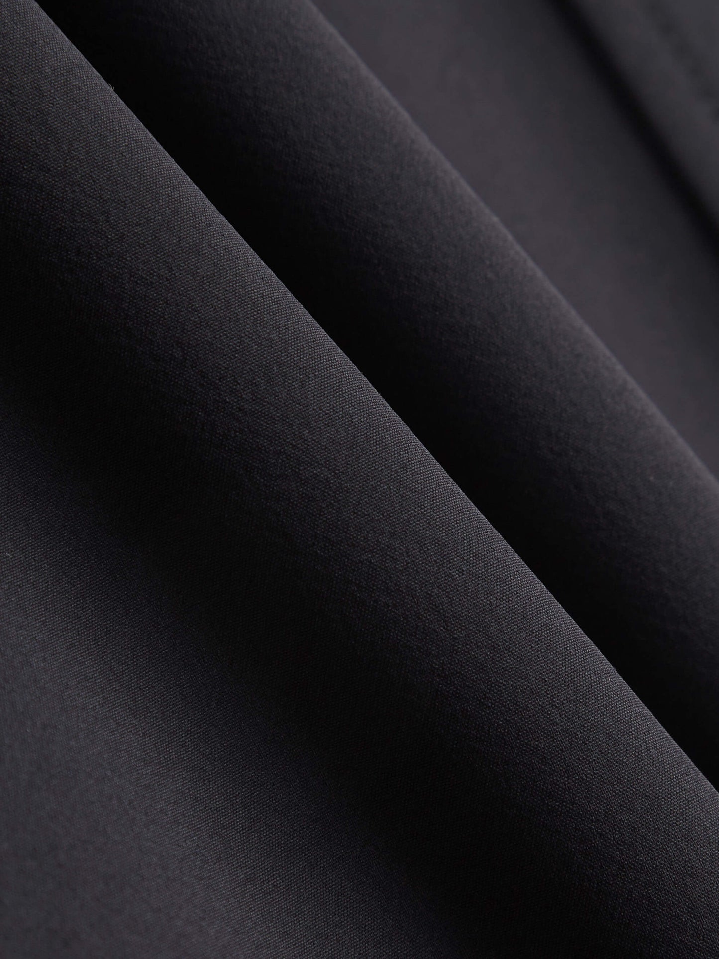 Fabric detail of black woven fleece pants