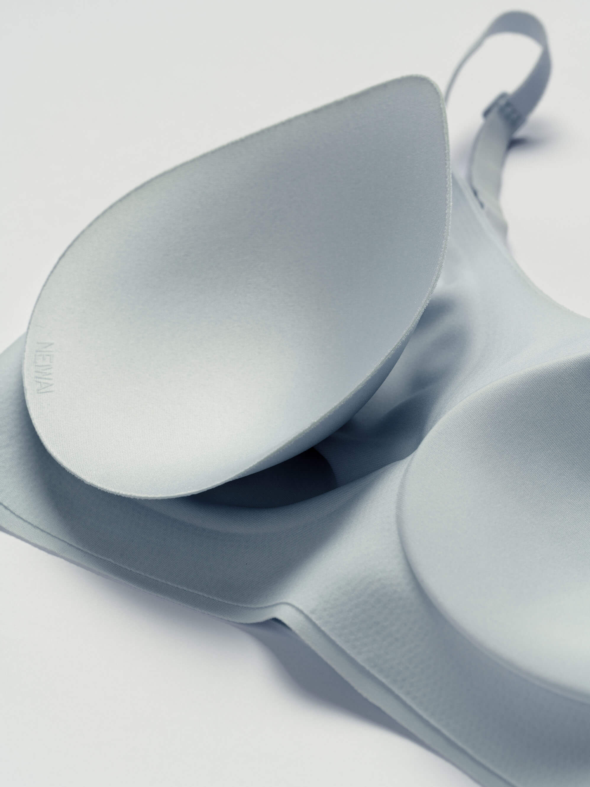 Close-up of light blue bra with one bra cup removed.