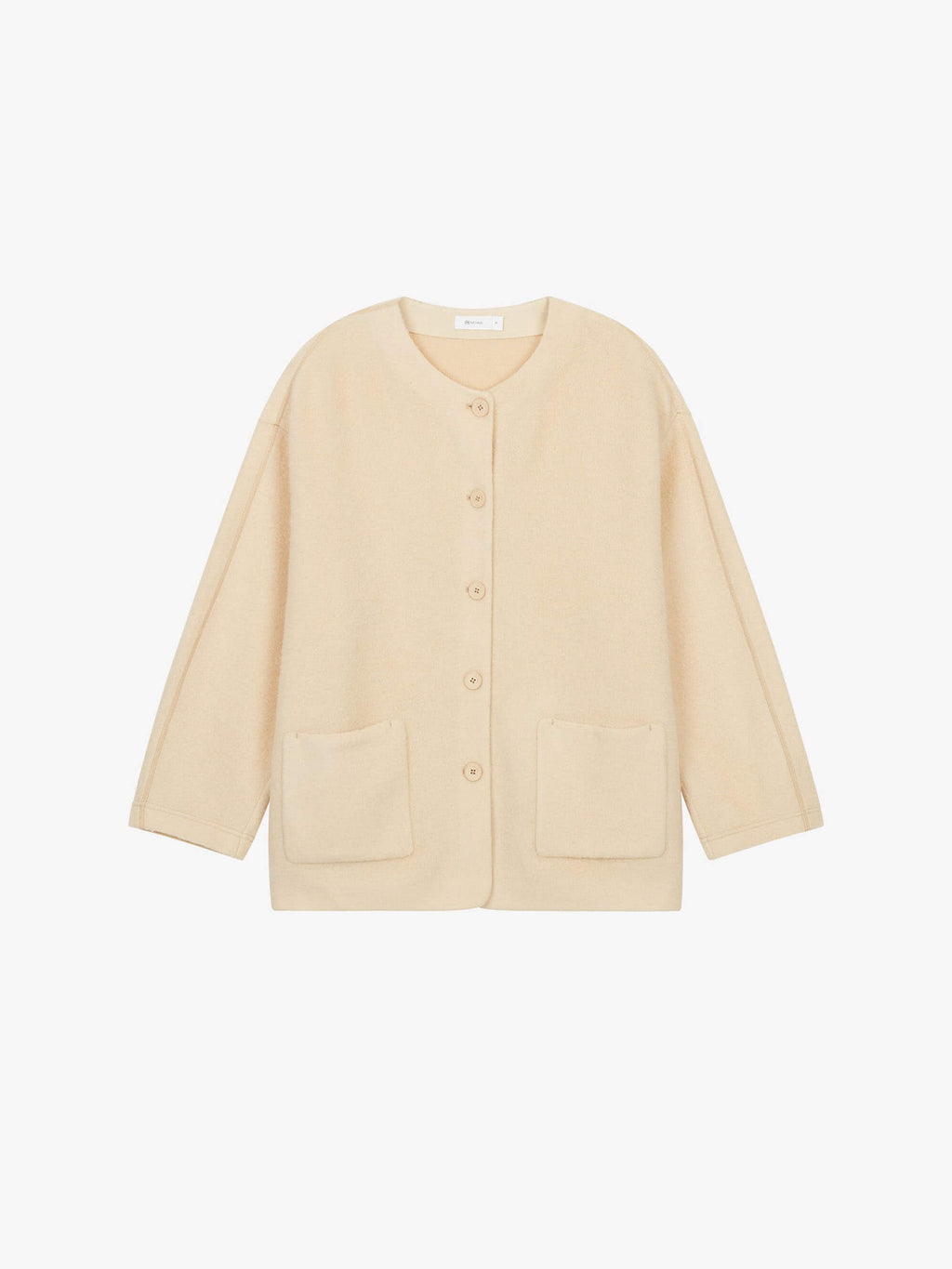 Flat lay of cream colored wool fleece jacket