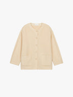 Flat lay of cream colored wool fleece jacket