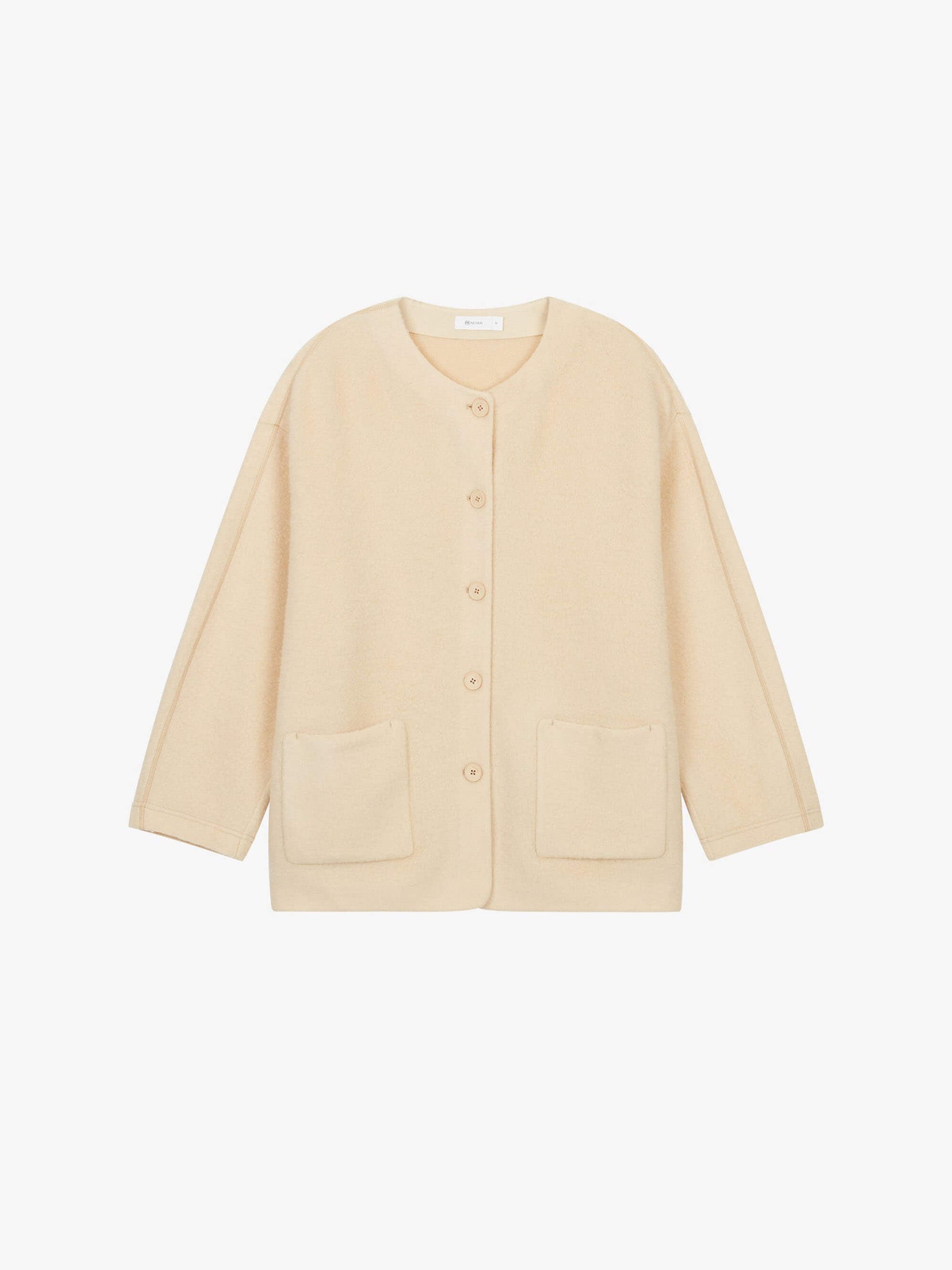 Flat lay of cream colored wool fleece jacket