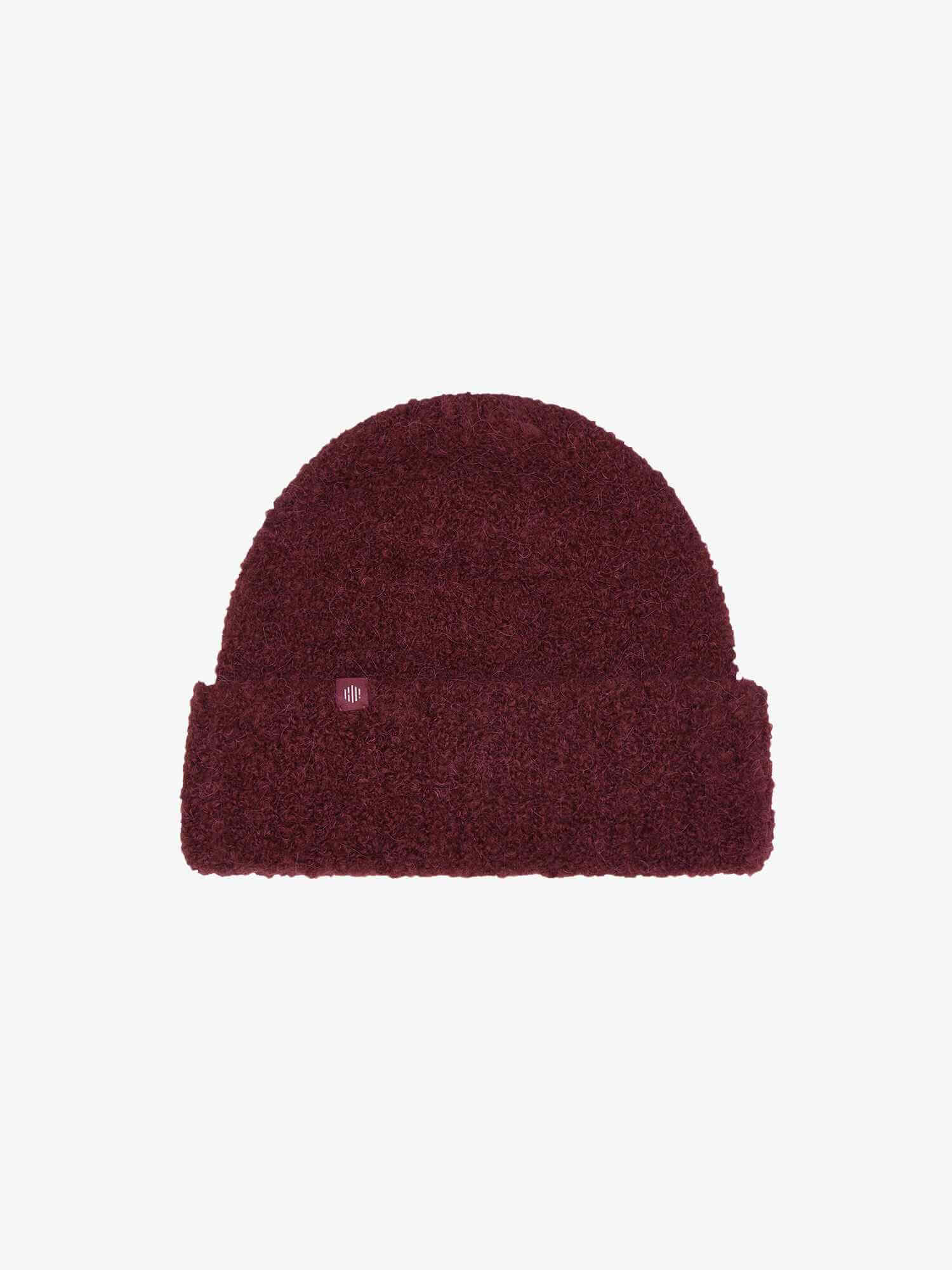 flat lay of burgundy beanie